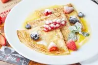 Блины с карамельно-апельсиновым соусом и свежими ягодами