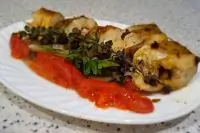 Хек с овощами и зеленью в духовке